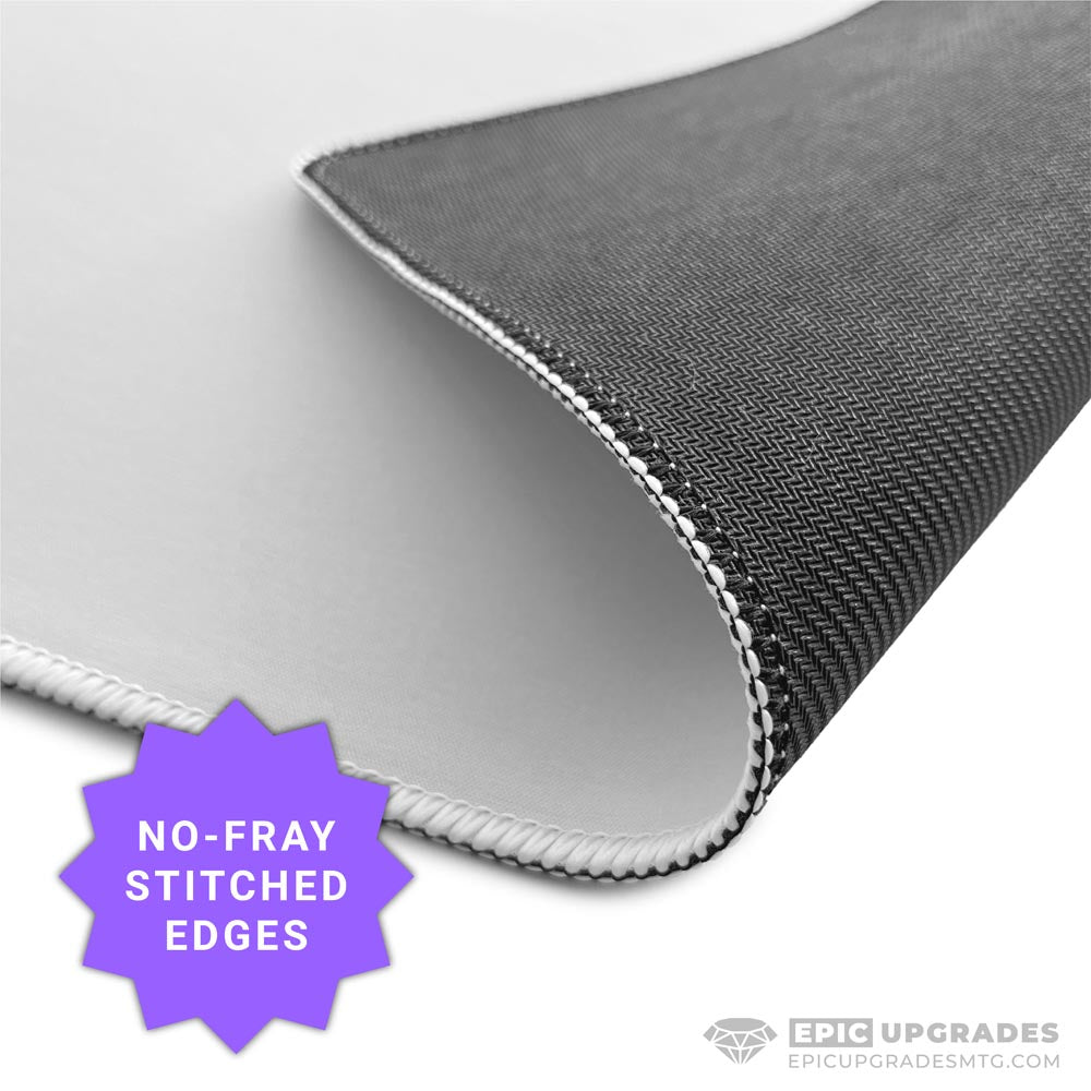 White 17x11 inch sublimation blank mat shown on a desk. Versatile surface works as a large mousepad, placemat, or small playmat. Smooth polyester top with black rubber backing, perfect for crafts, custom designs, and heat press printing. Ideal for personalized gifts, card games, or creative projects.