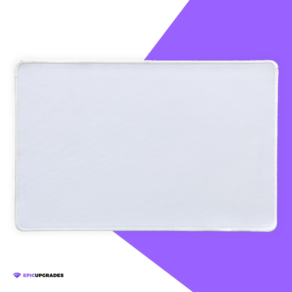 White 17x11 inch sublimation blank mat shown on a desk. Versatile surface works as a large mousepad, placemat, or small playmat. Smooth polyester top with black rubber backing, perfect for crafts, custom designs, and heat press printing. Ideal for personalized gifts, card games, or creative projects.