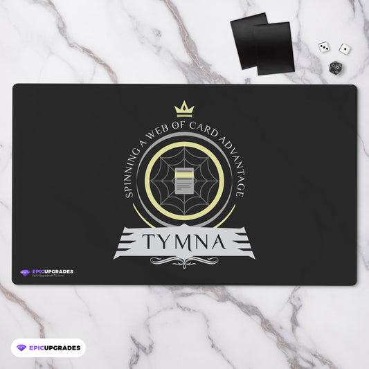 MTG-themed playmat featuring Tymna the Weaver, a legendary commander from the Magic: The Gathering card game. Tymna is a skilled weaver, surrounded by mystical threads and artifacts, ready to lead your deck to victory.
