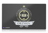 An elegant Orzhov-themed MTG playmat featuring a striking blend of black and white colors. Intricate motifs of angels, guild symbols, and opulent architecture adorn this beautifully designed playmat, capturing the essence of Orzhov's power and ambition.
